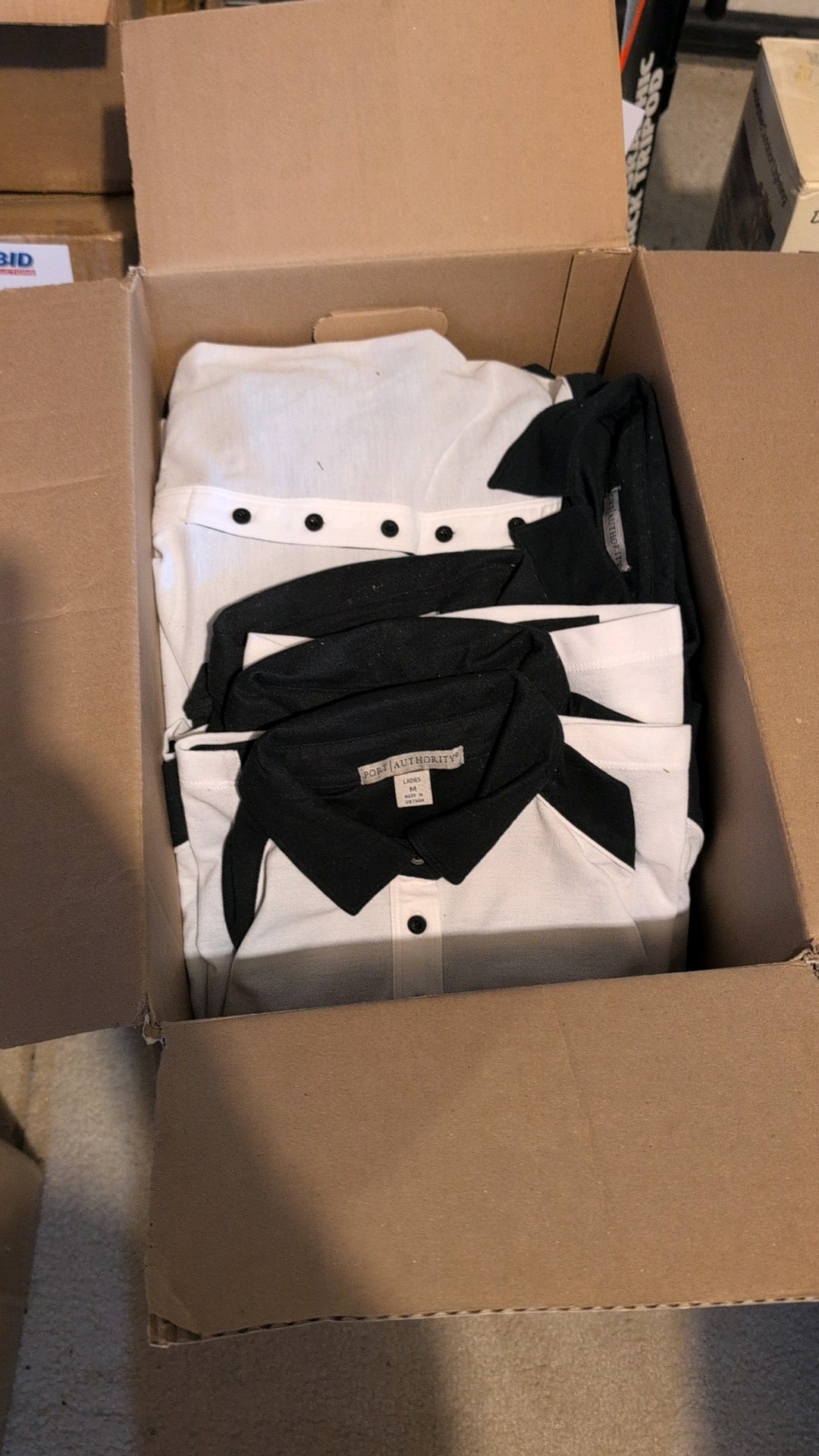 box of new ladies Port authority button-up collared shirts