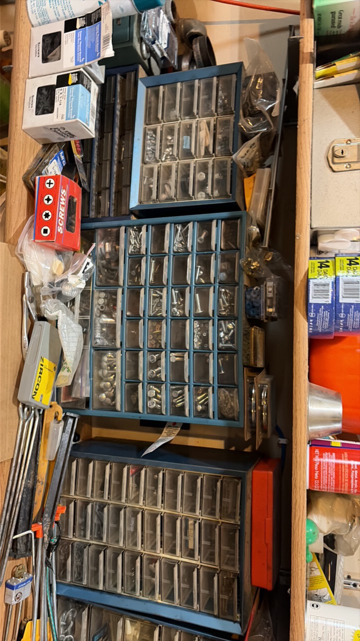 shelf contents including various screws, bolts, and nails