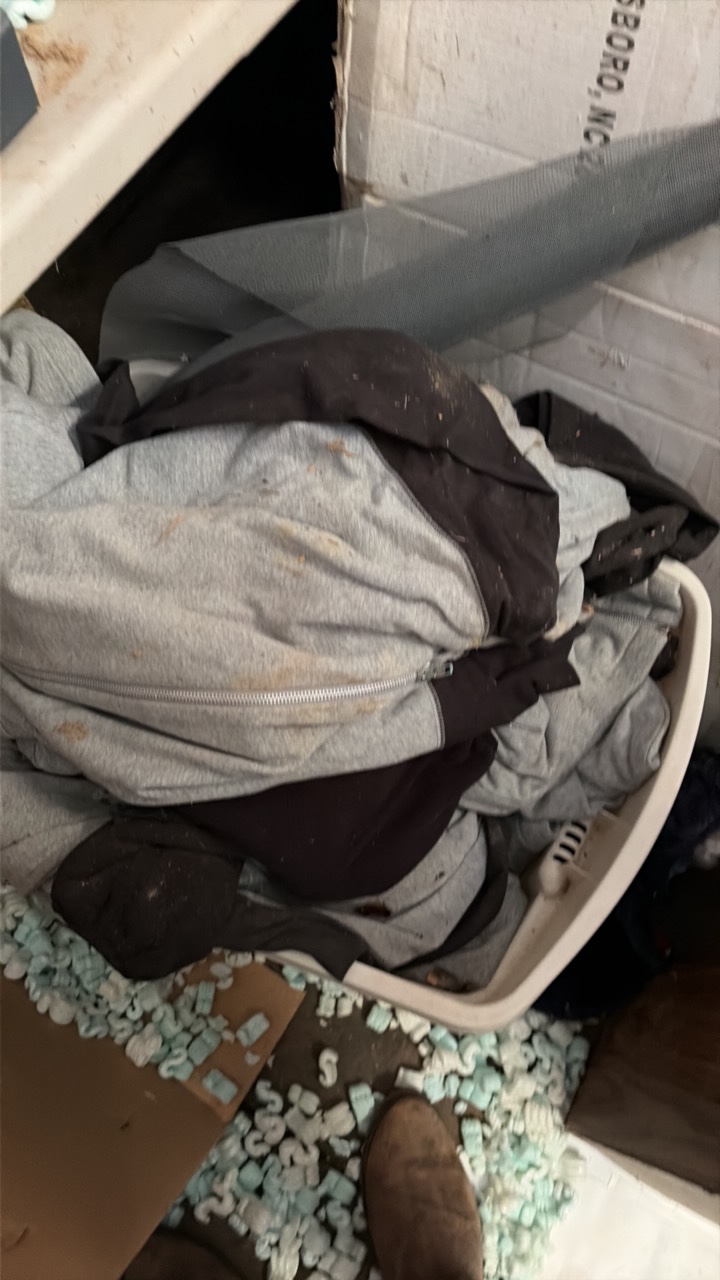 One container of various zip up hoodies and container of towels