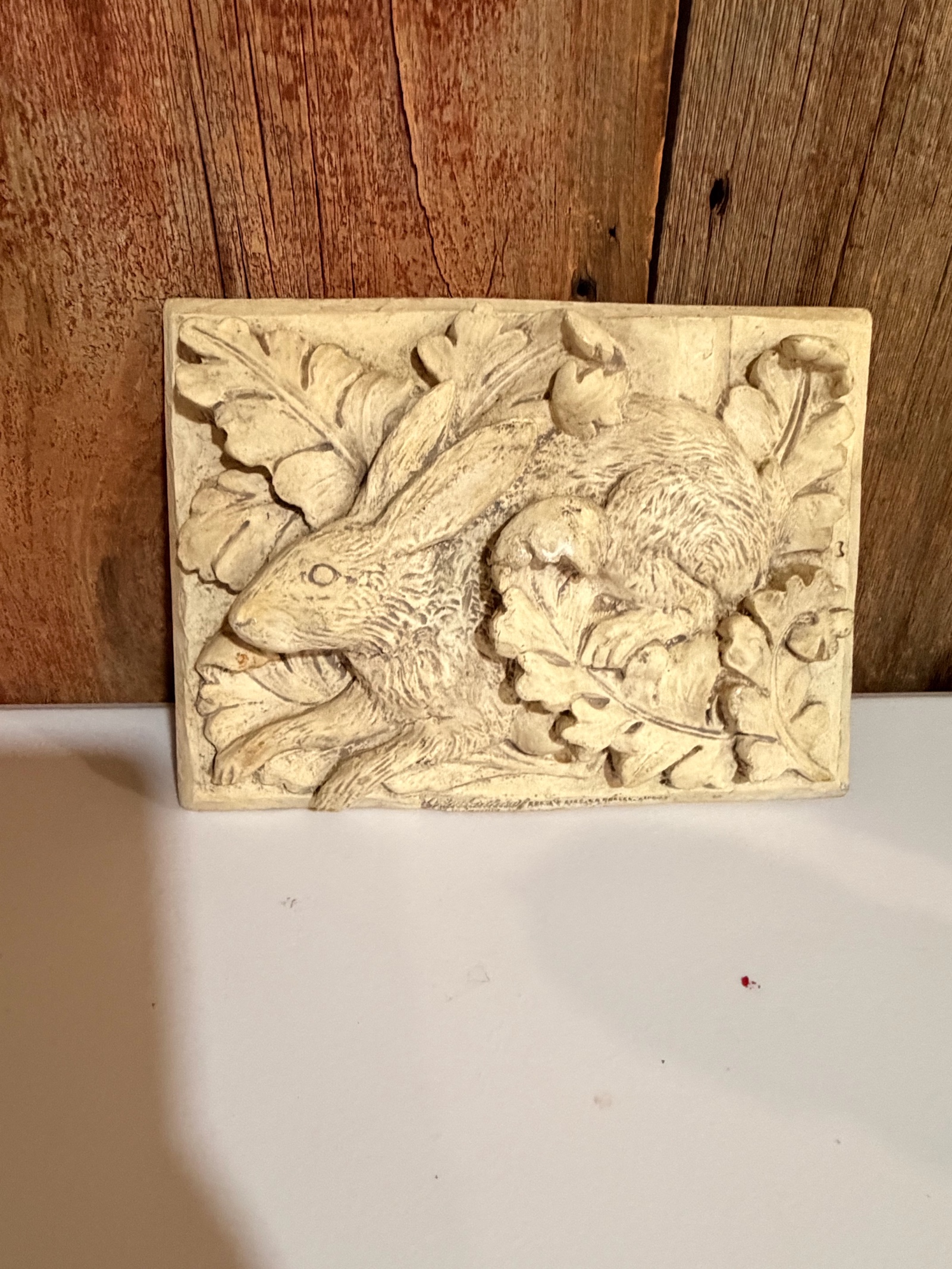 Bunny wall plaque crafted from stone.
