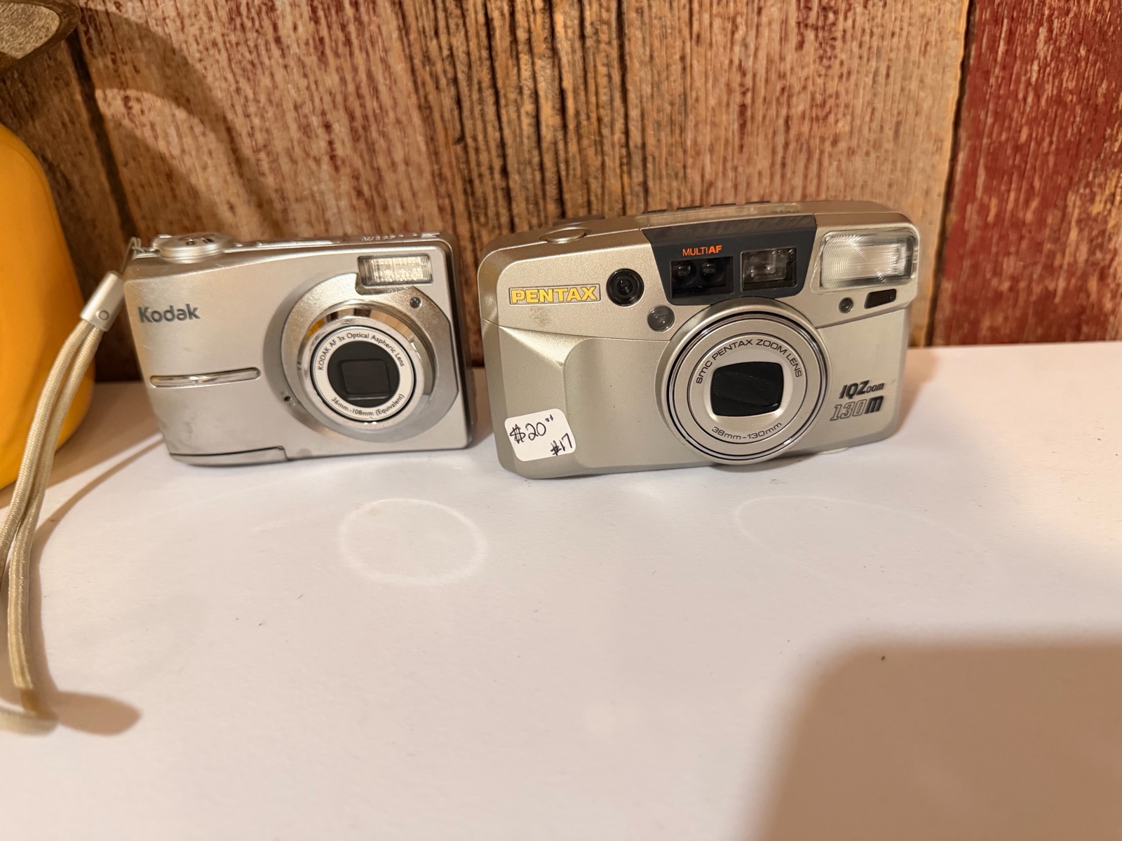 Pentax IQZoom 130M 35mm point-and-shoot film camera &Kodak EasyShare digital camera, likely the C913 model