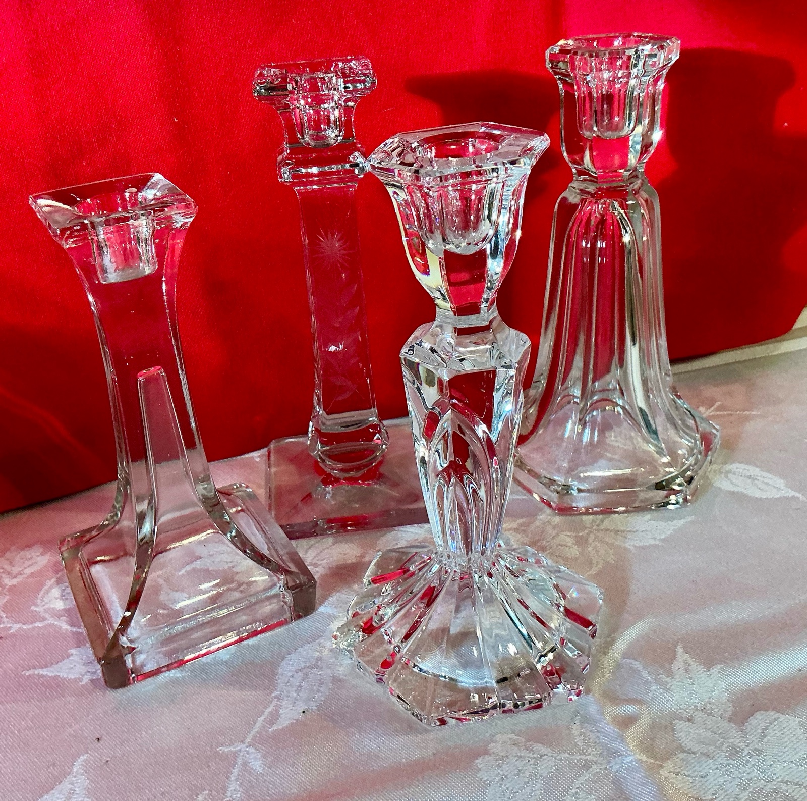 4 clear glass candlestick holders, 1 etched