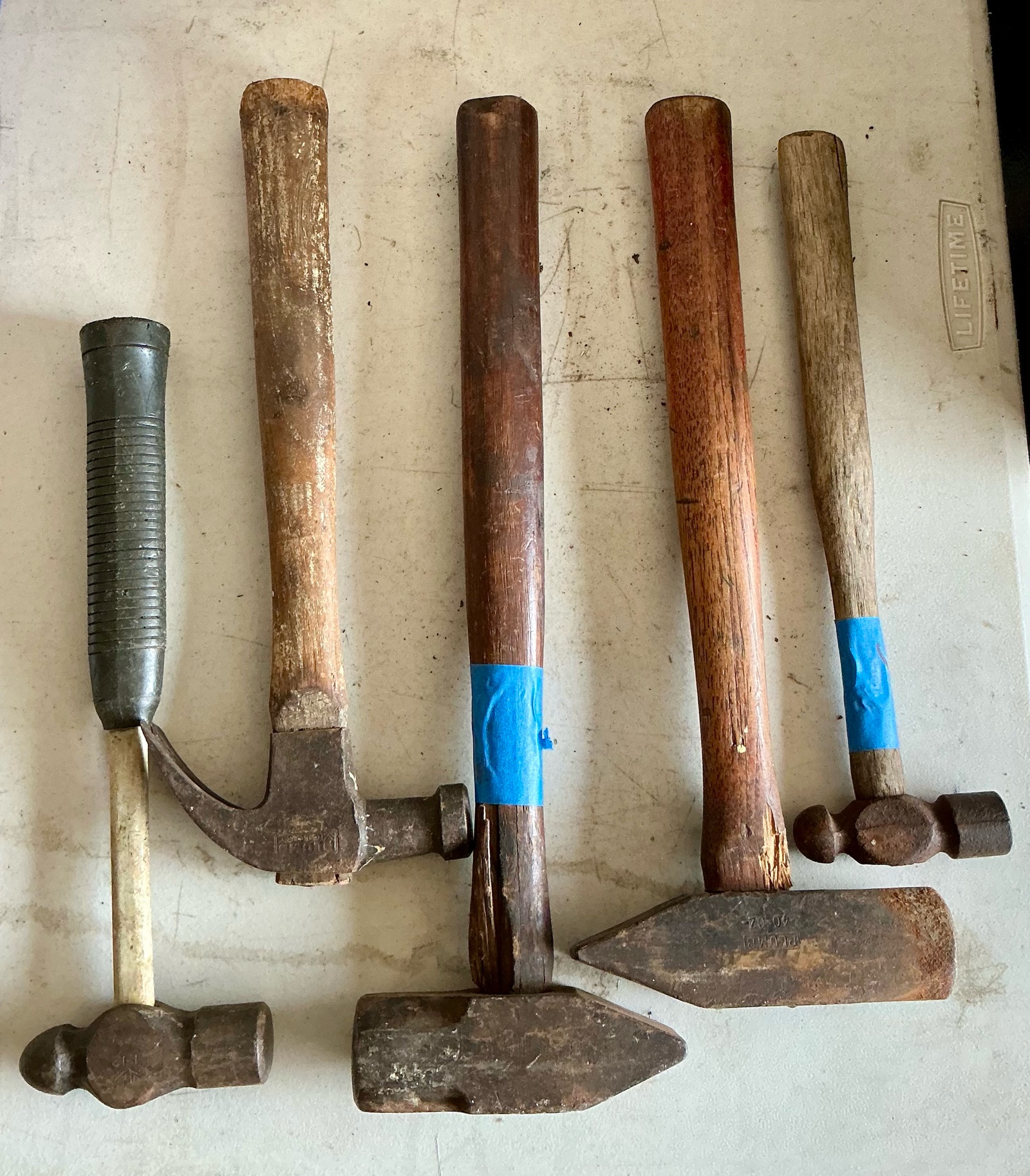 Vintage wood handled claw foot hammer and sledgehammers, plumb