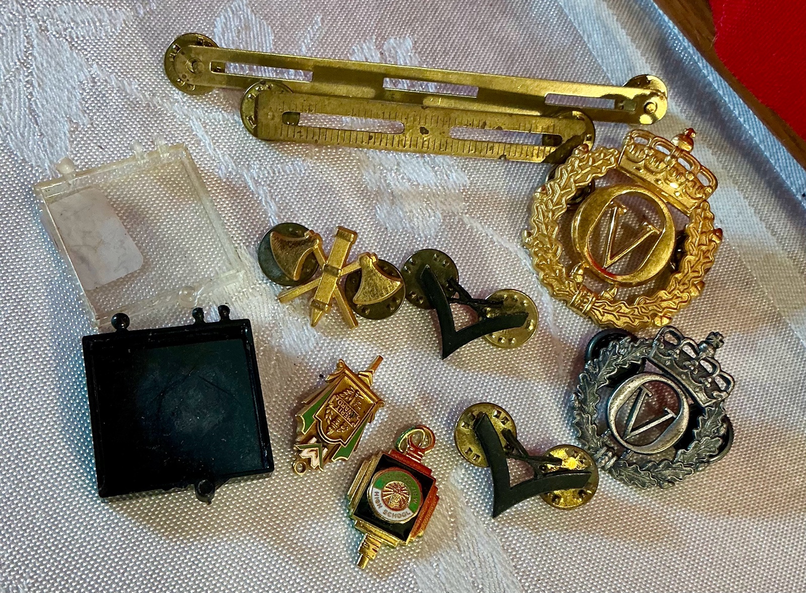 Group of military and merit award pins Norwegian cap badges