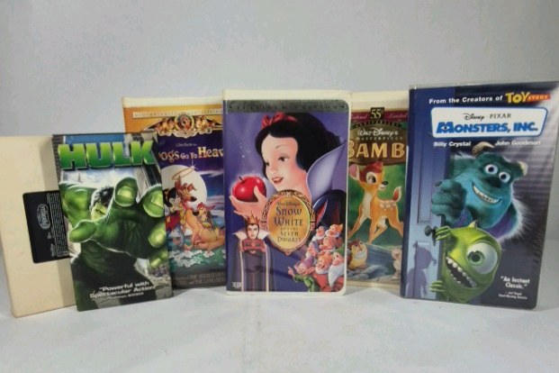 Assorted VHS movies including Disney titles Snow White, Bambi, Monsters Inc, and Hercules along with Hulk. Mixed family and animated films in standard VHS cases shown.
