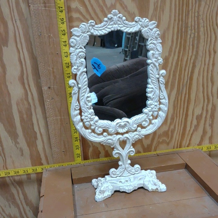 vintage Victorian-style cast iron vanity mirror