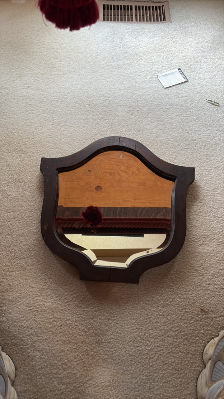 Vintage wood framed, shieldship-crest shaped mirror