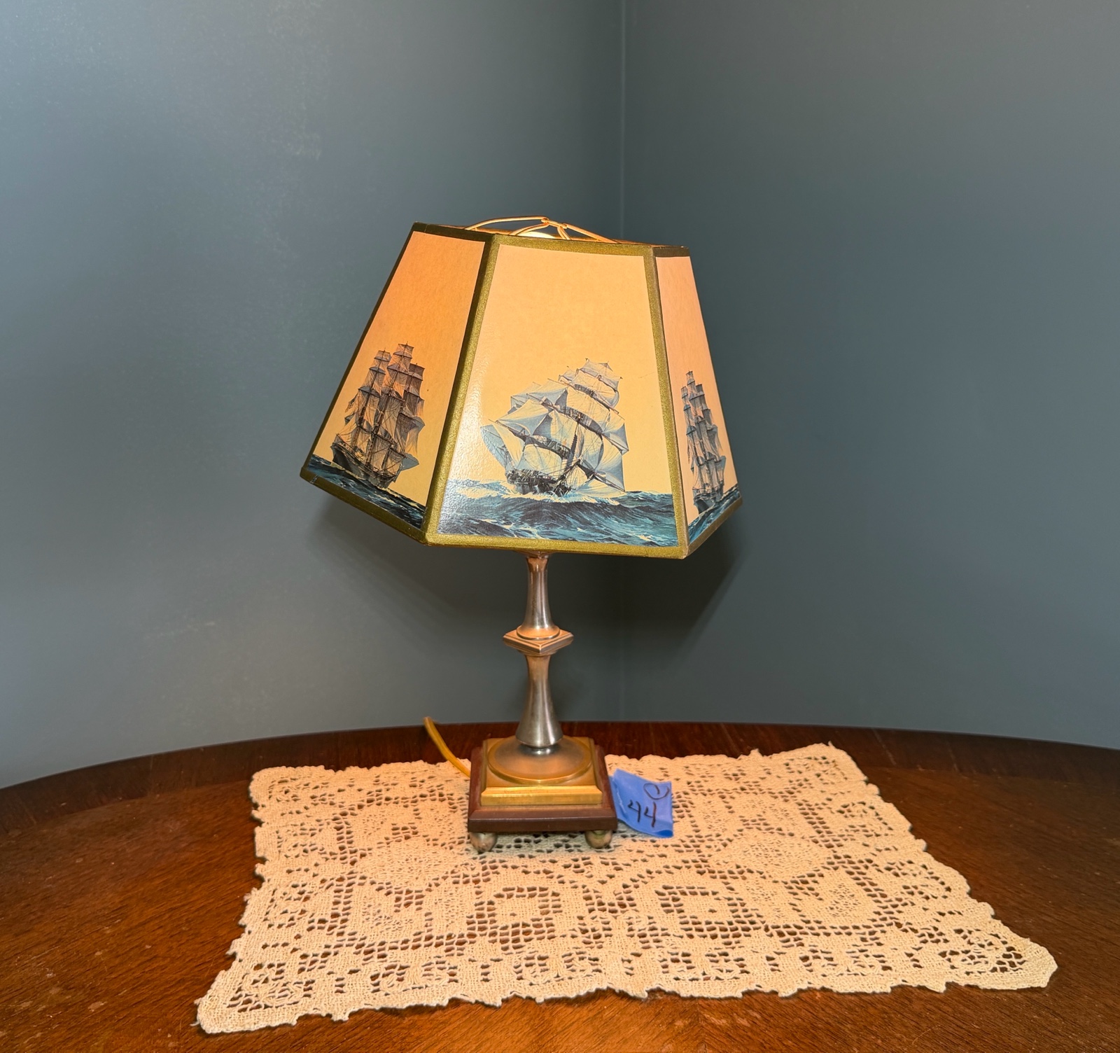 Vintage nautical-themed table lamp with doily