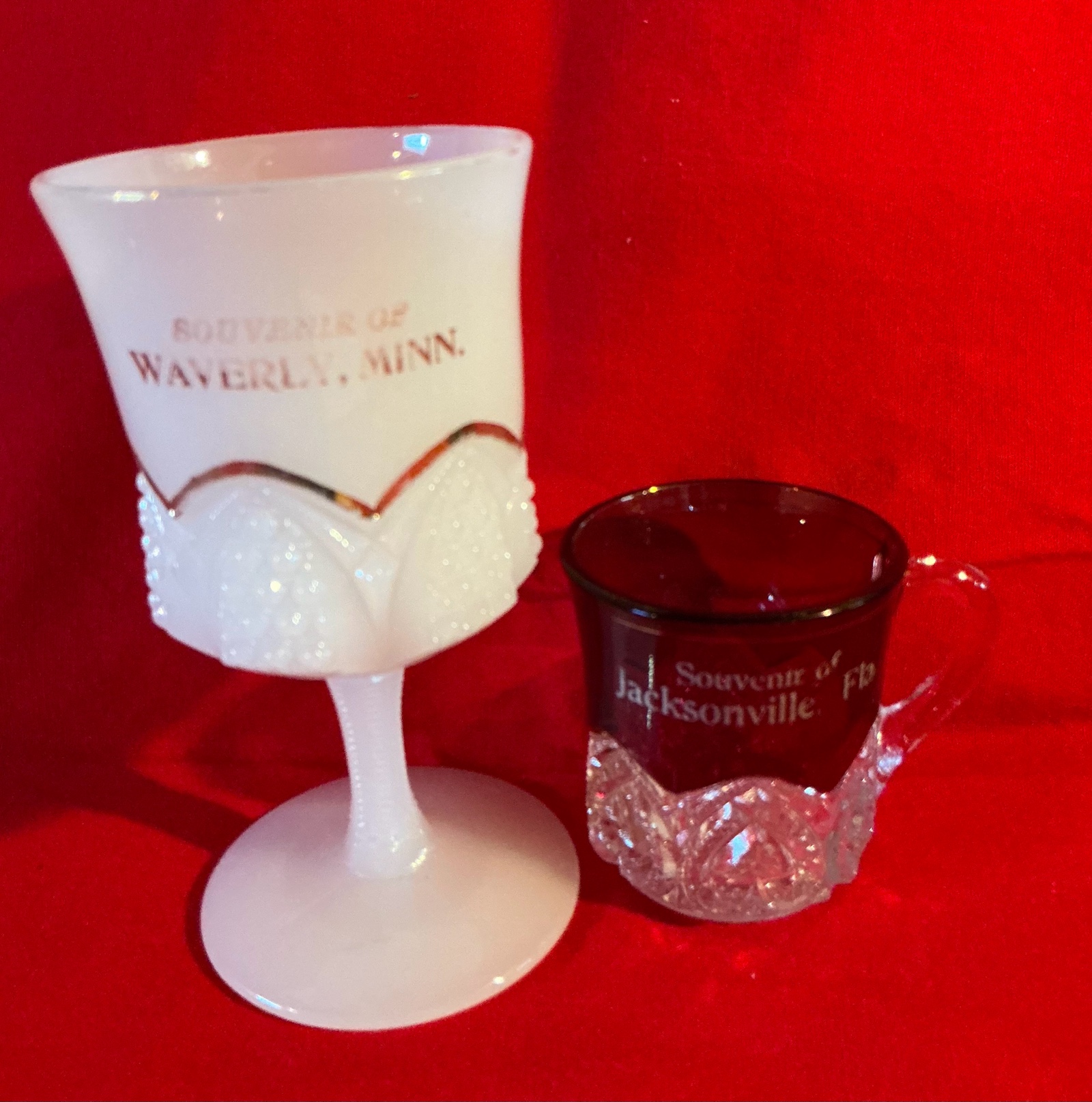 Pair of glass souvenir cups ruby red and milk glass