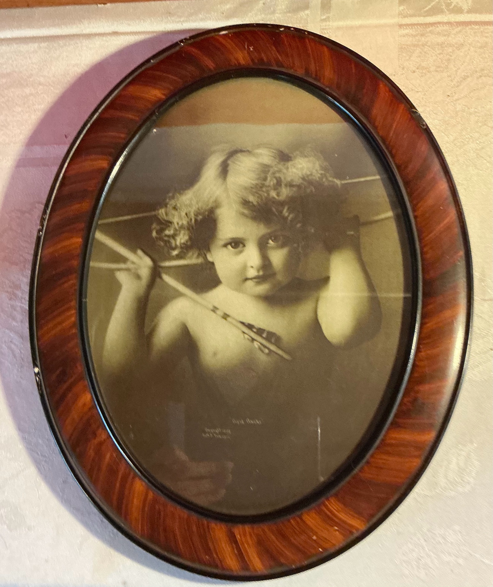 Vintage cupid awake lithograph by M. V. Parkinson in oval frame