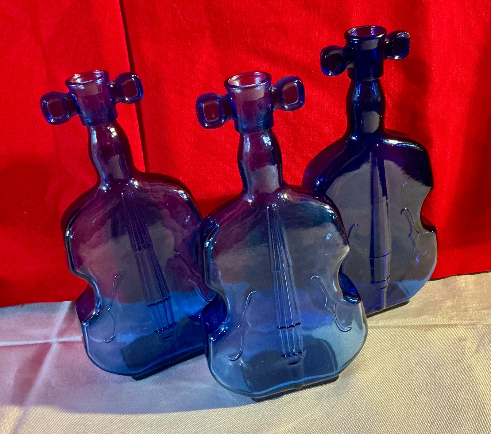 Collectable group of cello shaped cobalt blue glass bottles