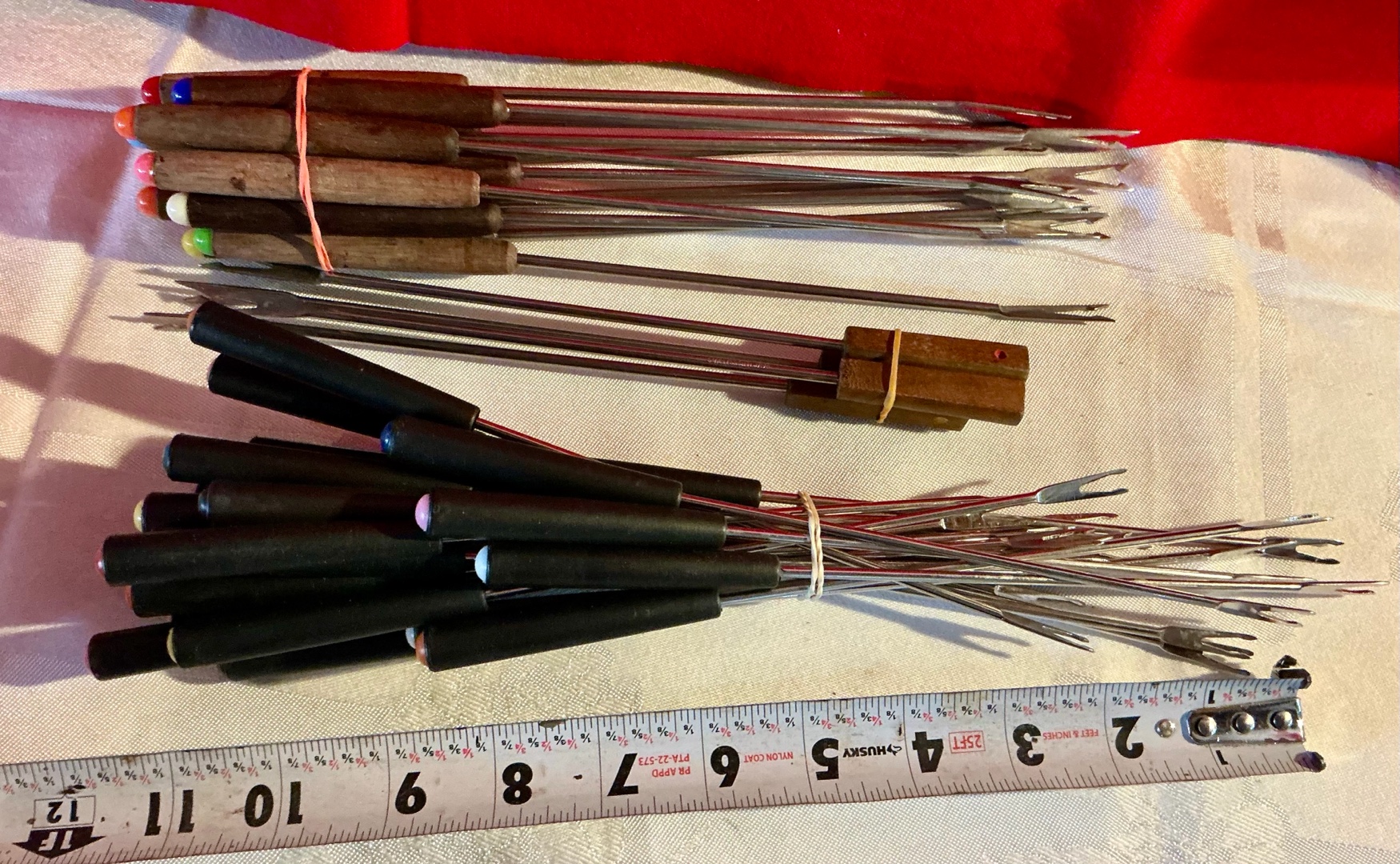 Large group of fondue forks wood handles