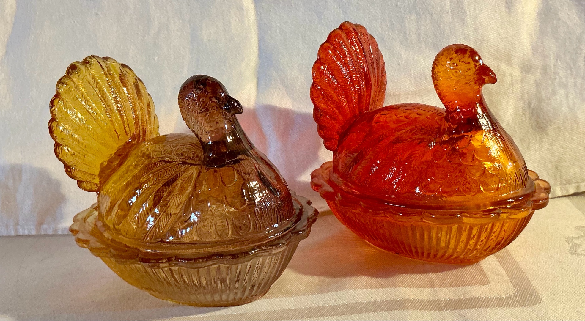 Pair glass hens on a nest, amber & redorange amberina candy dishes