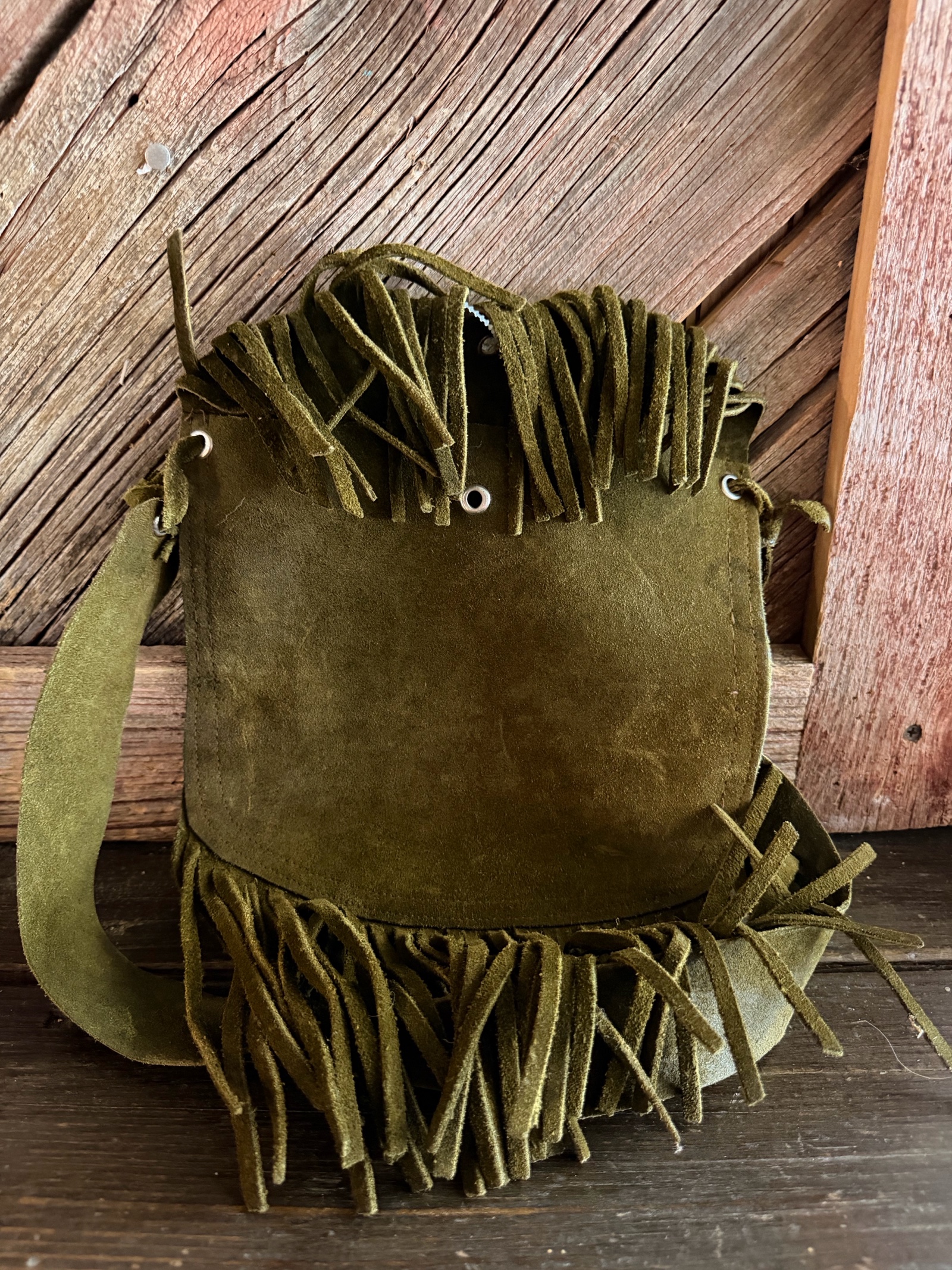 handmade moss green suede leather bohemian-style crossbody bag with fringe detailing.